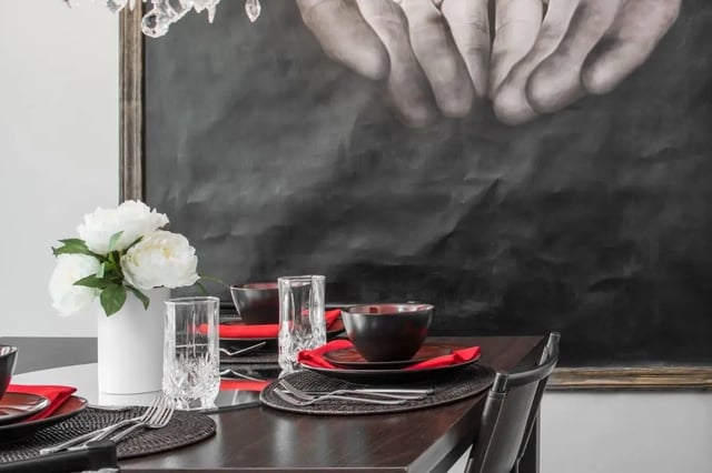 Table setting with flowers and artwork dining area at The George in Statesboro Student Accommodation