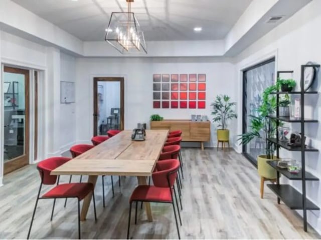 Large wooden table red chairs communal area at East Edge in Tuscaloosa Student Accommodation
