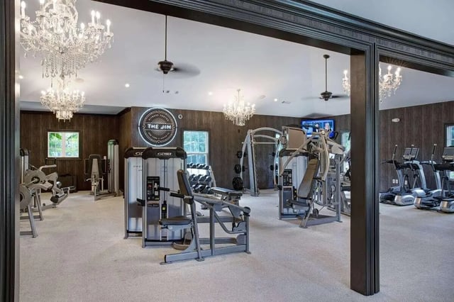 Various weight machines treadmills and chandeliers fitness center at The George in Statesboro Student Accommodation