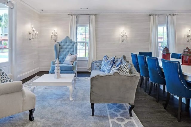 Tufted chairs table and sofa living room at The George in Statesboro Student Accommodation