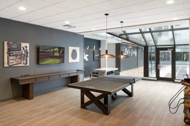 Ping pong table on wooden floor common area at The Quad On Delaware in Minneapolis Student Accommodation