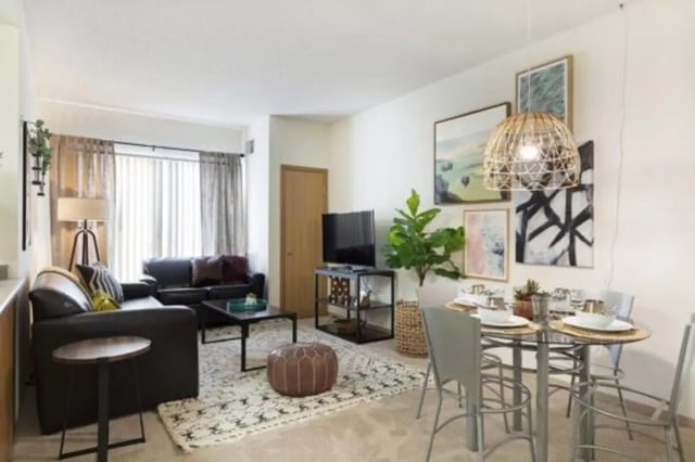 Sofa TV dining table and art living room at The Quad On Delaware in Minneapolis Student Accommodation