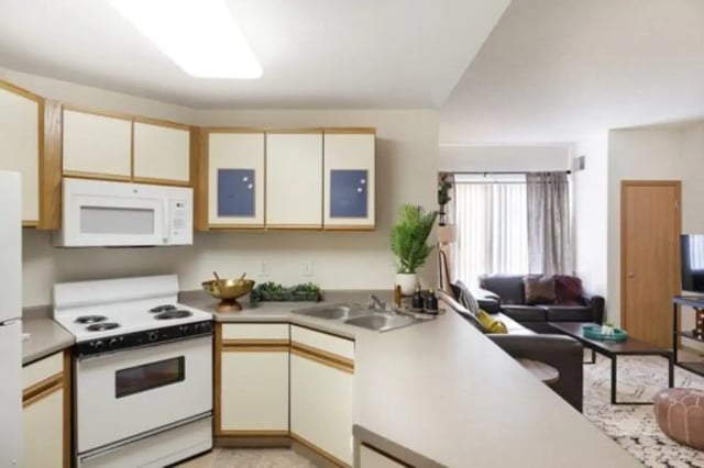 Stove microwave sink cabinets living room kitchen at The Quad On Delaware in Minneapolis Student Accommodation