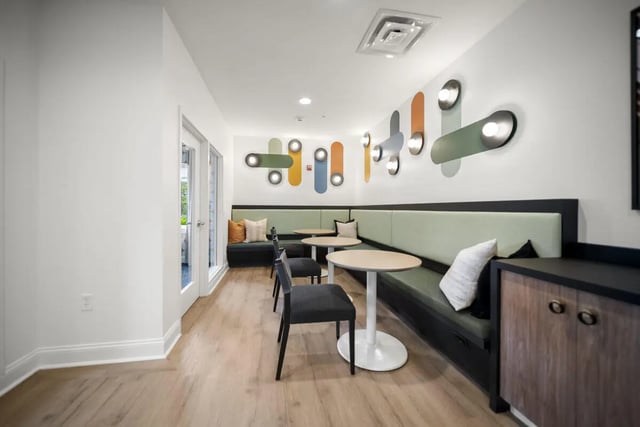 Banquette seating tables chairs and modern wall art lounge area at Block20