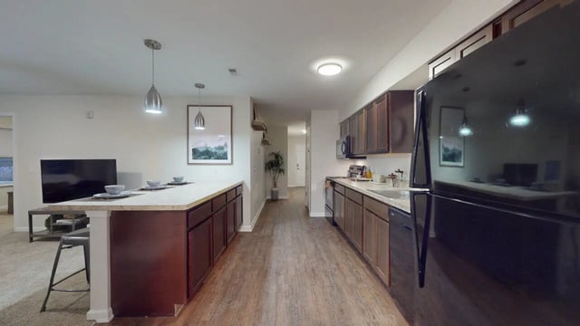 Island with stools and large refrigerator kitchen at Block20