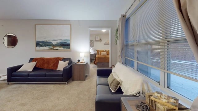 Two sofas artwork and bedside table living room at Block20