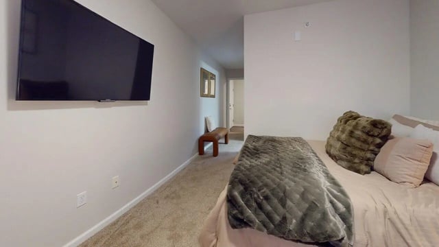 Bed with plush pillows and TV bedroom at Block20
