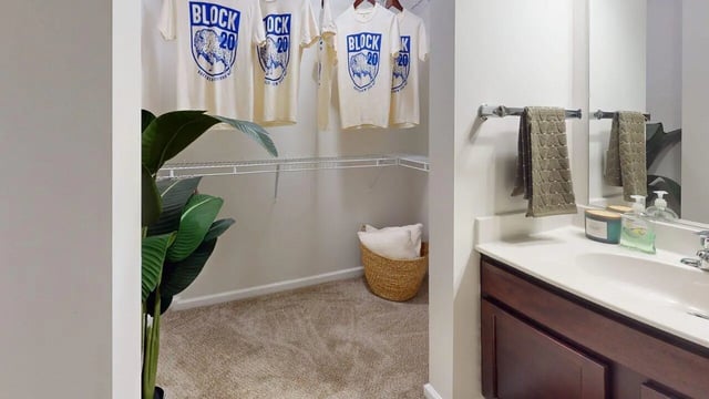 T-shirts on hangers basket on carpet bathroom vanity Bathroom at Block20