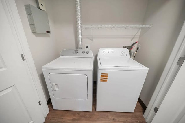 Two white laundry machines and shelf Laundry Room at Block20