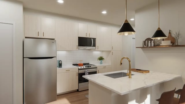 Stainless steel refrigerator stove and kitchen island kitchen at The Sinclair in Austin Student Accommodation