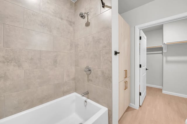Tiled shower bathtub wood cabinets walk in closet bathroom at The Sinclair in Austin Student Accommodation