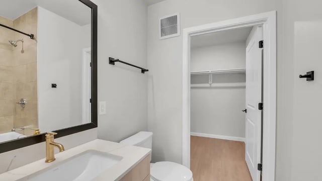 Sink toilet and closet with shelves bathroom at The Sinclair in Austin Student Accommodation
