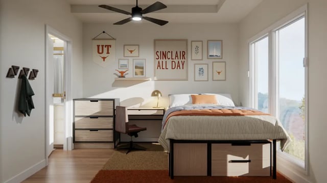 Bed desk dresser wall art and ceiling fan bedroom at The Sinclair in Austin Student Accommodation