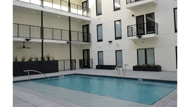 Courtyard with pool and balconies swimming pool exterior at The Sinclair in Austin Student Accommodation