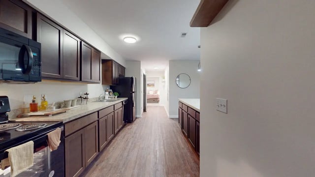 Doors open to kitchen and closet interior at Block20