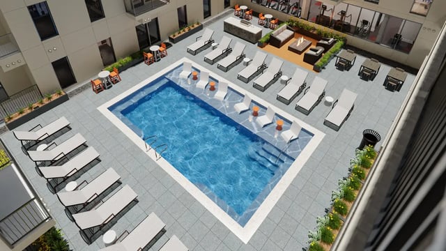 Pool lounge chairs tables outdoor seating courtyard exterior at The Sinclair in Austin Student Accommodation