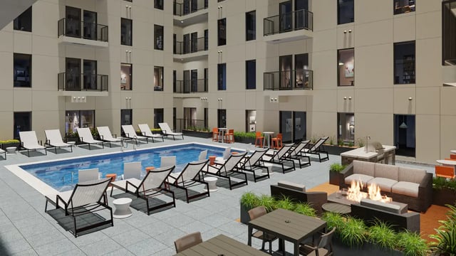 Pool lounge chairs fire pit and outdoor kitchen exterior at The Sinclair in Austin Student Accommodation