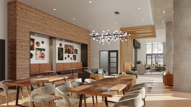 Large dining tables chairs artworks lounge area common room at The Sinclair in Austin Student Accommodation
