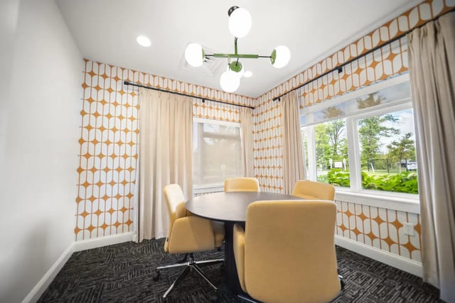 Round table chairs patterned wallpaper meeting room at Block20