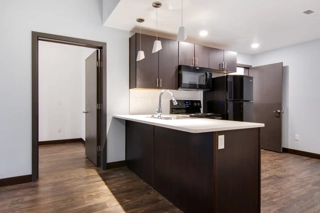 Modern kitchen with dark cabinets refrigerator stove microwave kitchen at 800 South in Springfield Student Accommodation