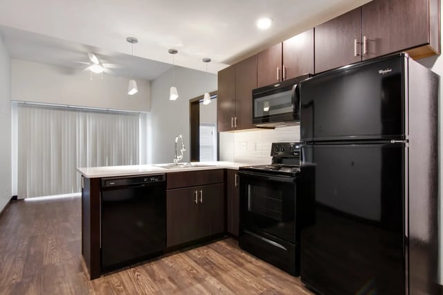 Black appliances and dark cabinets kitchen area at 800 South in Springfield Student Accommodation