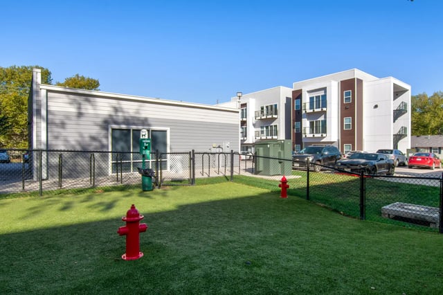 Dog park with hydrants and apartment buildings exterior at 800 South in Springfield Student Accommodation