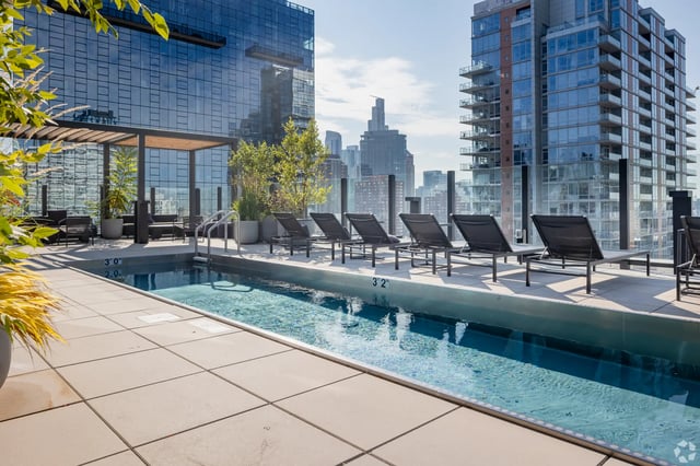 Pool deck with lounge chairs exterior at Straits Row in Chicago Student Accommodation
