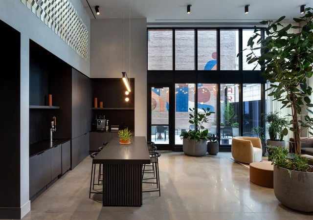 Modern communal area with kitchen and seating. at Straits Row in Chicago Student Accommodation