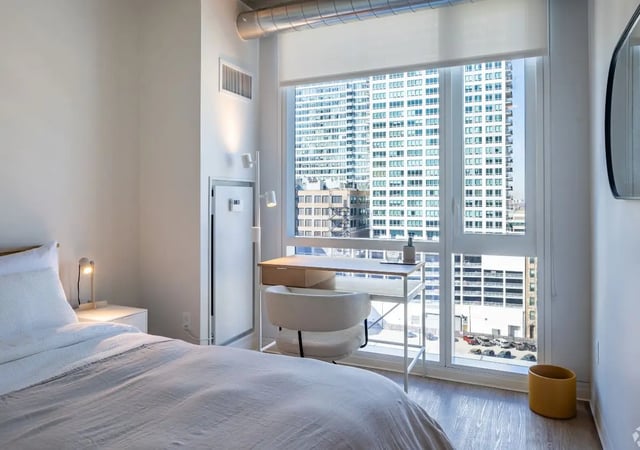 Bed desk and city view bedroom at Straits Row in Chicago Student Accommodation