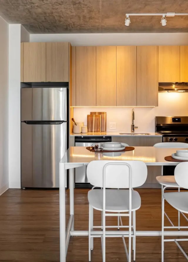 Stainless steel fridge modern cabinets white table kitchen at Straits Row in Chicago Student Accommodation