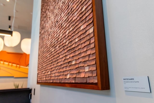 Textured wood art with informational plaque living room at Straits Row in Chicago Student Accommodation