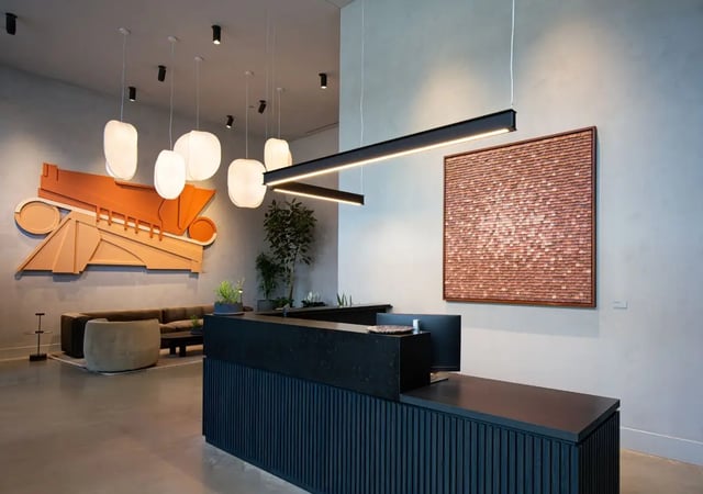 Reception desk with computer and artwork lobby at Straits Row in Chicago Student Accommodation