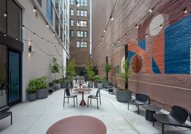Outdoor seating area with tables and chairs patio at Straits Row in Chicago Student Accommodation