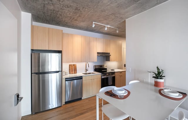 Stainless steel refrigerator wood cabinets dining table kitchen at Straits Row in Chicago Student Accommodation