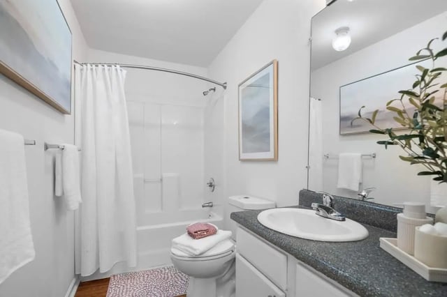 White bathtub toilet sink art towels bathroom at Astoria in Denton Student Accommodation