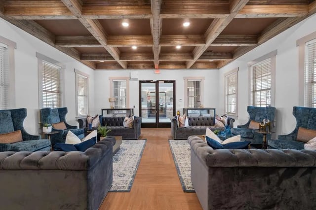 Blue chairs and grey sofas in a living room at Astoria in Denton Student Accommodation