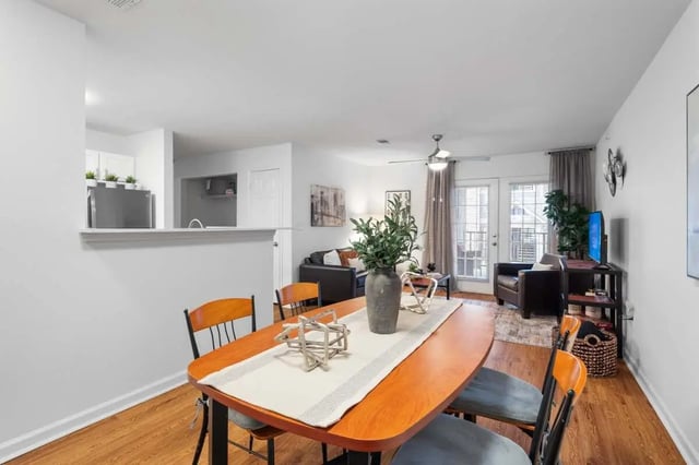 Dining table with chairs living room kitchen exterior at Astoria in Denton Student Accommodation