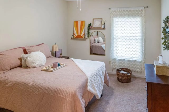 Pink bed white blanket tray decor bedroom at The Bluff at Waterworks Landing in Tuscaloosa Student Accommodation