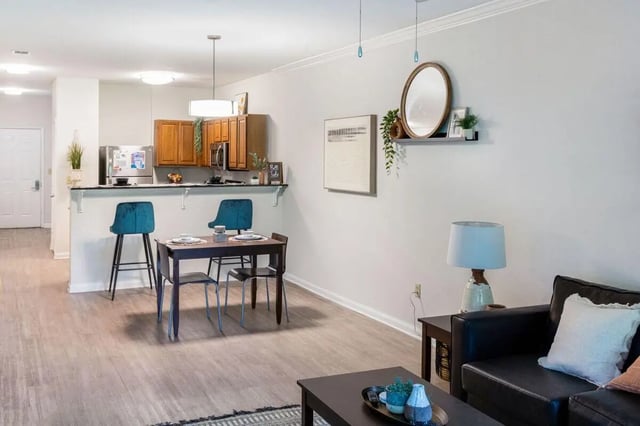 Kitchen dining area and living room interior at The Bluff at Waterworks Landing in Tuscaloosa Student Accommodation