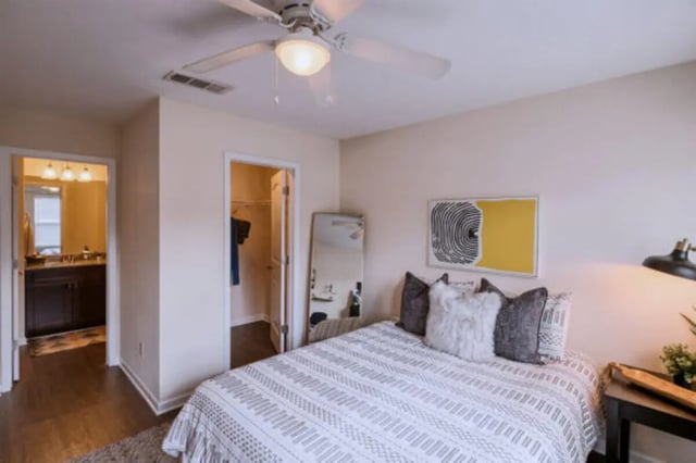 Bed with patterned comforter closet and bathroom bedroom at Athens Ridge in Athens Student Accommodation