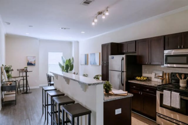 Kitchen with dark cabinets granite counter stainless steel appliances kitchen at Athens Ridge in Athens Student Accommodation