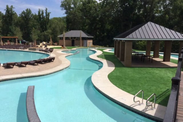 Swimming pool with cabanas and lounge chairs exterior at Athens Ridge in Athens Student Accommodation