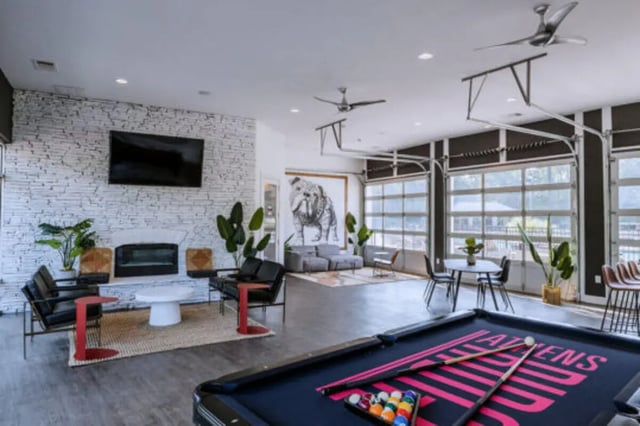 Pool table couches fireplace and tv living room at Athens Ridge in Athens Student Accommodation