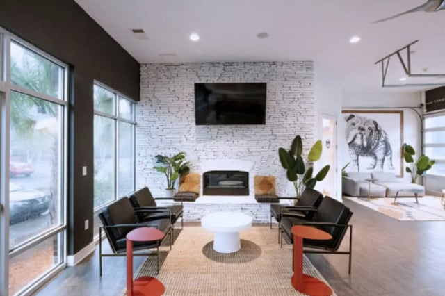 Modern lounge with fireplace black sofas living room at Athens Ridge in Athens Student Accommodation
