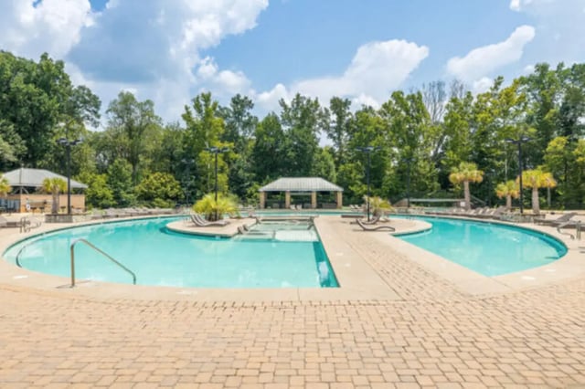 Resort-style pool with lounging deck and trees Exterior at Athens Ridge in Athens Student Accommodation