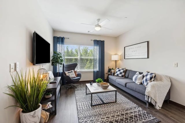 Sofa armchair coffee table rug living room at The Valley Apartments & Townhomes in State College Student Accommodation