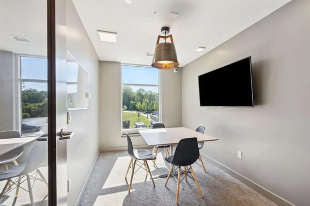 Table with chairs TV and window study area at The Valley Apartments & Townhomes in State College Student Accommodation
