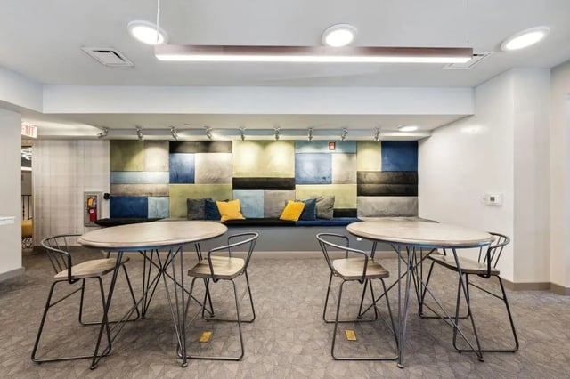 Two oval tables with chairs and cushioned bench living room at The Valley Apartments & Townhomes in State College Student Accommodation