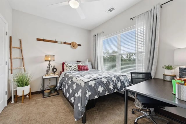 Bed desk chair ladder and plant bedroom at The Valley Apartments & Townhomes in State College Student Accommodation
