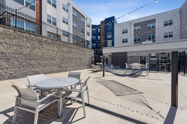 Hammock and table with chairs patio exterior at The Valley Apartments & Townhomes in State College Student Accommodation